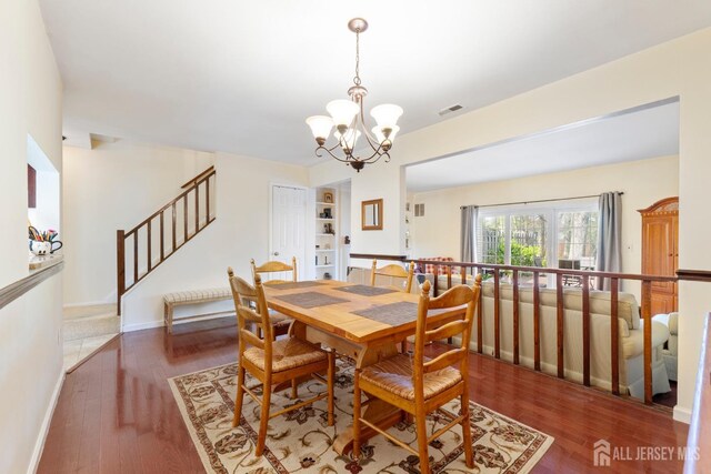 135 Archery Ct, Old Bridge, NJ 08857 - dining room with visible vents, wood finished floors, stairway, baseboards, and a chandelier