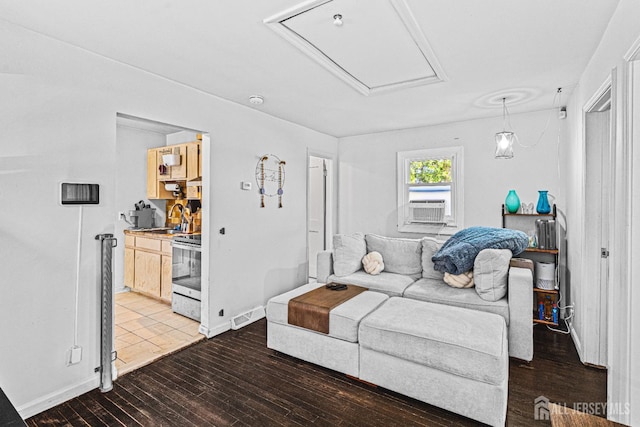 426 Catherine St, South Amboy, NJ 08879 - living area with attic access, wood finished floors, cooling unit, and baseboards
