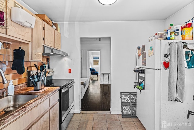 426 Catherine St, South Amboy, NJ 08879 - kitchen featuring stainless steel electric stove, freestanding refrigerator, under cabinet range hood, light brown cabinets, and a sink
