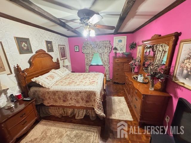 bedroom featuring a ceiling fan, beam ceiling, and ornamental molding