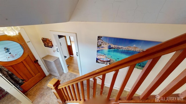 stairs with vaulted ceiling