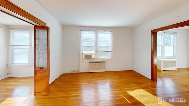 spare room featuring light hardwood / wood-style flooring and radiator heating unit