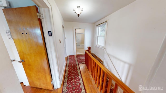 hallway with light hardwood / wood-style floors