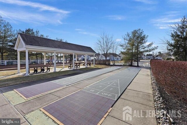 view of property's community with a gazebo and shuffleboard