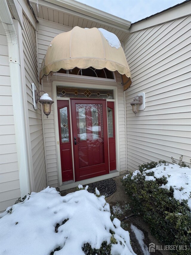 view of snow covered property entrance