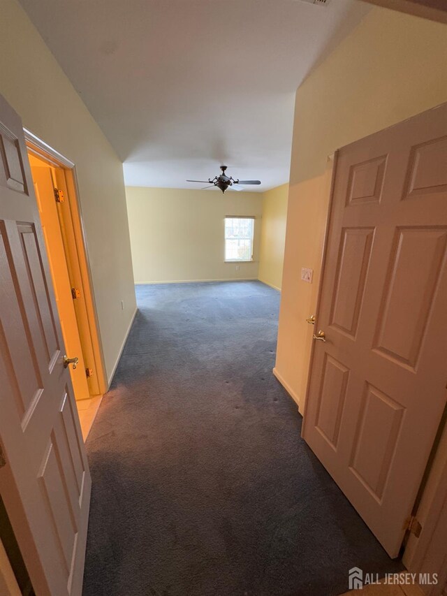 hall with baseboards and carpet flooring