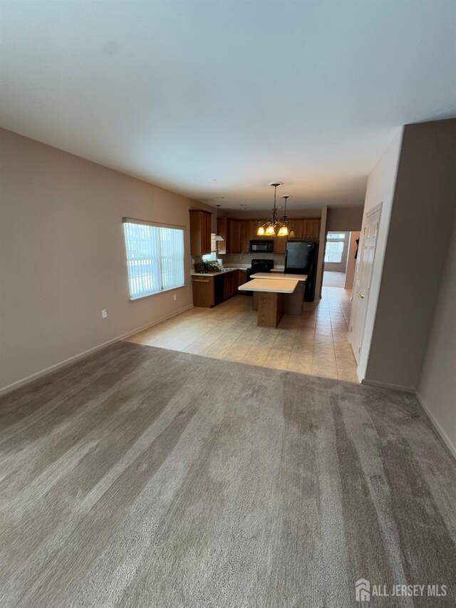 unfurnished living room featuring light colored carpet