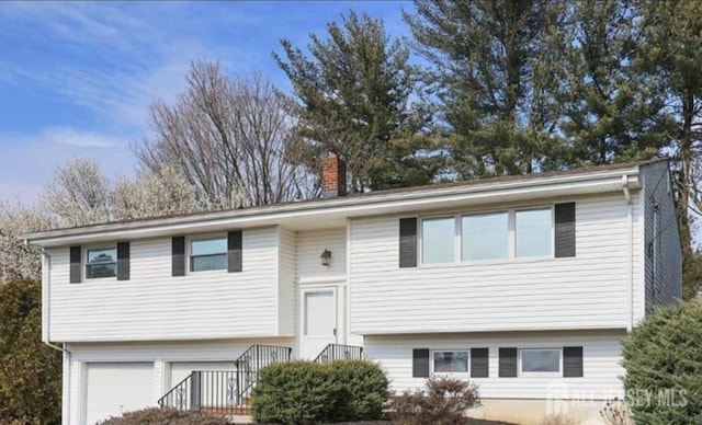 205 N Moetz Dr, Milltown, NJ 08850 - bi-level home featuring a chimney and an attached garage