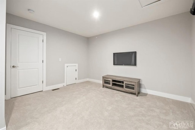 unfurnished living room featuring baseboards and carpet floors