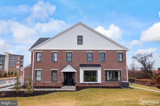 view of front of house featuring brick siding, central AC unit, and a front lawn