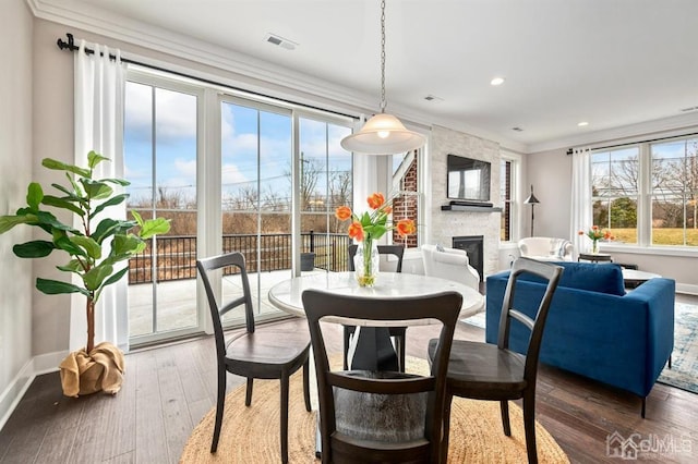 dining room featuring recessed lighting, visible vents, a stone fireplace, and baseboards