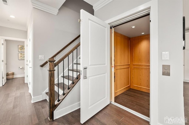 stairs featuring baseboards, elevator, visible vents, and wood finished floors