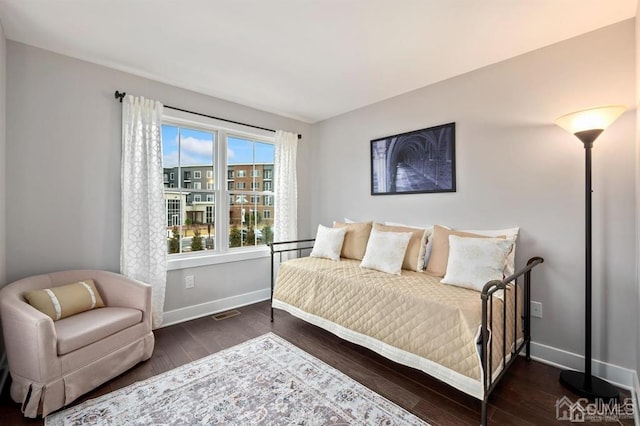 bedroom with baseboards and wood finished floors