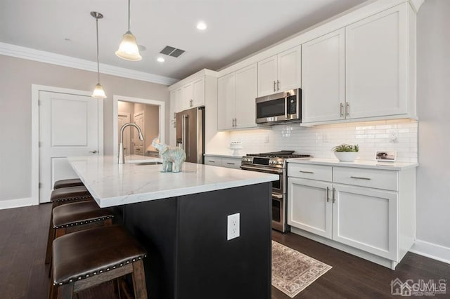 kitchen featuring ornamental molding, backsplash, visible vents, stainless steel appliances, and a sink