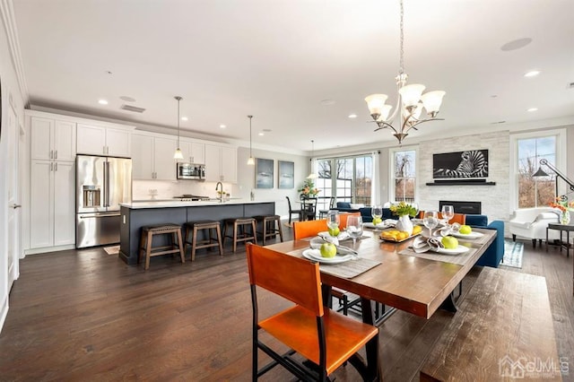 dining area with visible vents, recessed lighting, an inviting chandelier, and dark wood-style floors