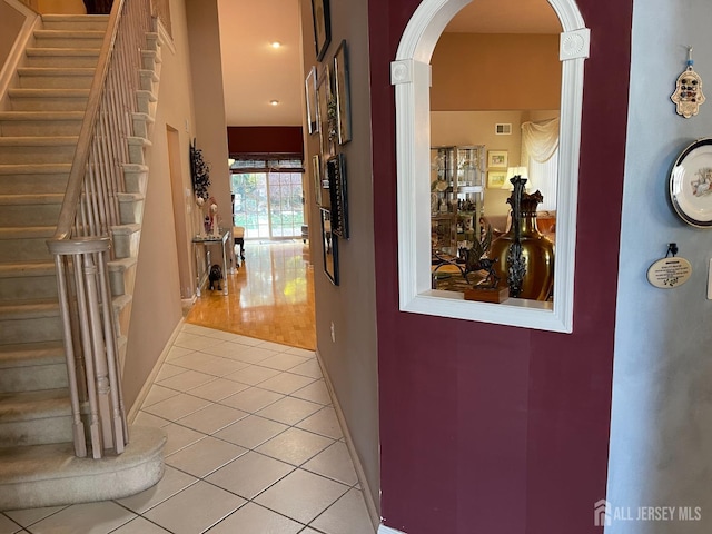 hallway featuring light tile patterned floors