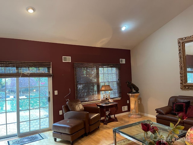 living room with lofted ceiling and light hardwood / wood-style flooring