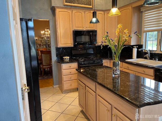 kitchen with light tile patterned floors, sink, hanging light fixtures, black appliances, and decorative backsplash