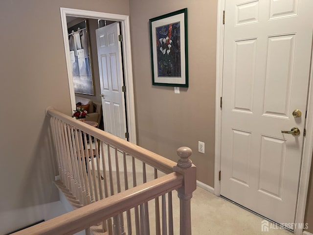 corridor with light colored carpet