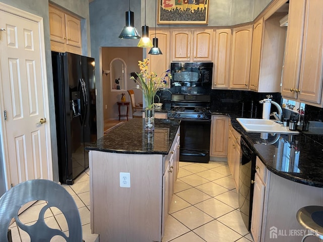 kitchen featuring black appliances, a center island, dark stone countertops, and decorative light fixtures