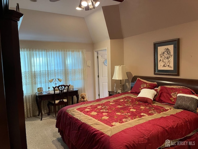 bedroom featuring lofted ceiling, ceiling fan, and carpet flooring