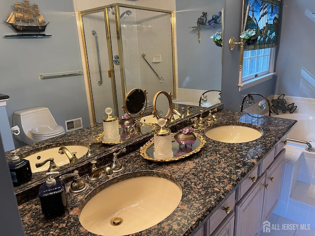 full bathroom featuring vanity, tile patterned floors, independent shower and bath, and toilet