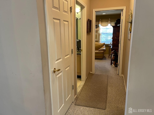 corridor featuring light colored carpet