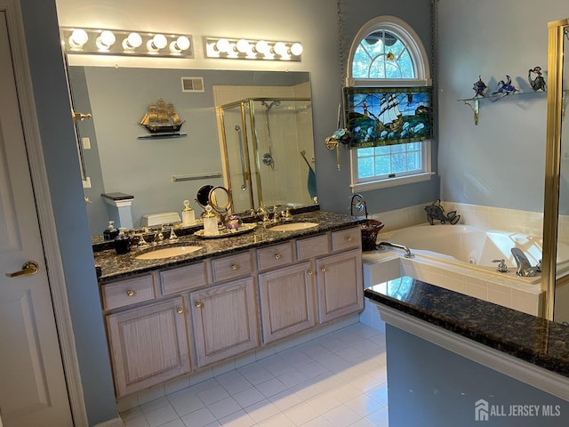 bathroom with tile patterned flooring, plus walk in shower, and vanity