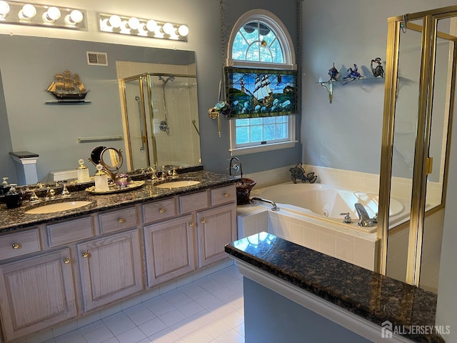 bathroom with vanity, plus walk in shower, and tile patterned flooring