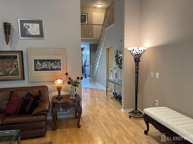 interior space with light hardwood / wood-style floors and a high ceiling