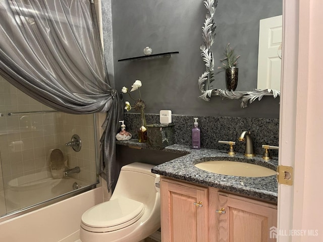 full bathroom with vanity, enclosed tub / shower combo, and toilet