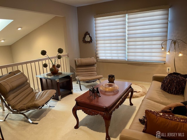 sitting room with light carpet and a skylight