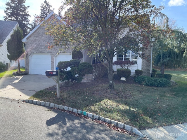 view of front of home with a garage and a front yard