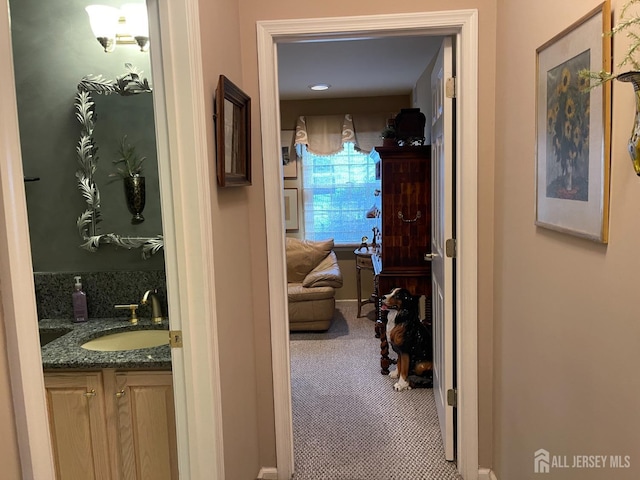 corridor featuring carpet floors and sink