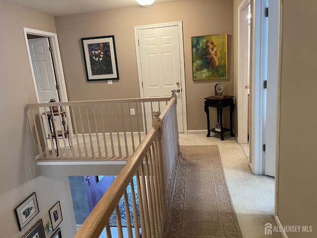 hallway featuring light carpet