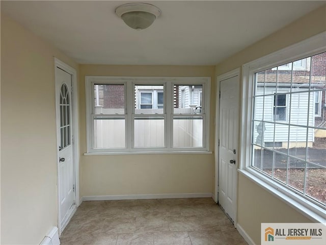 unfurnished sunroom featuring a healthy amount of sunlight