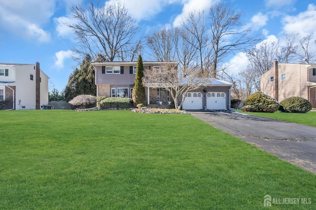 view of front of property featuring aphalt driveway, an attached garage, brick siding, and a front yard