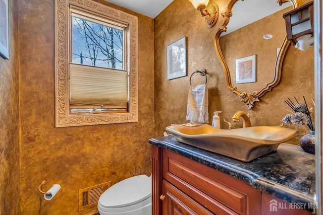 bathroom with vanity and toilet