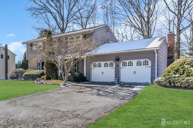 view of property with a garage and a front yard