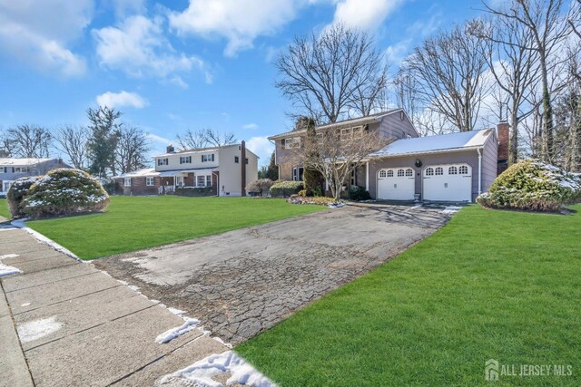 view of front of home with a garage and a front yard