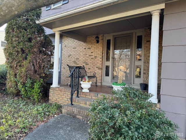 view of exterior entry featuring a porch