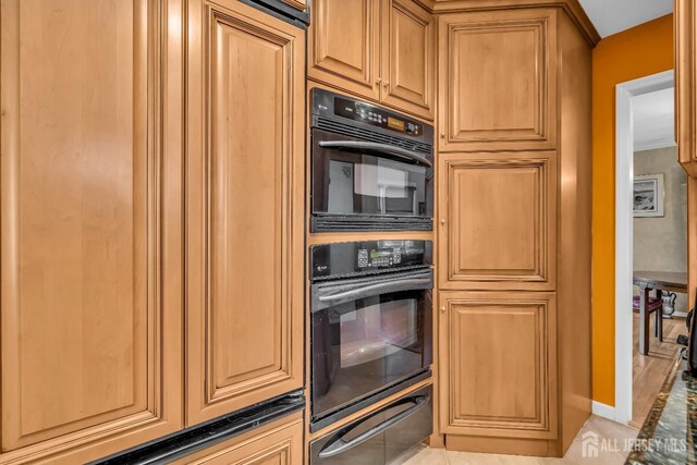 kitchen featuring double oven and light tile patterned floors