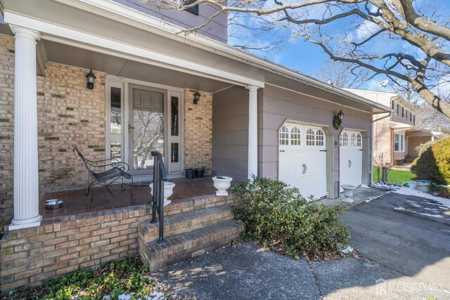 entrance to property with a garage and a porch