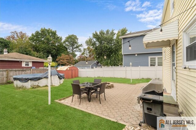 view of yard featuring a covered pool and a patio area