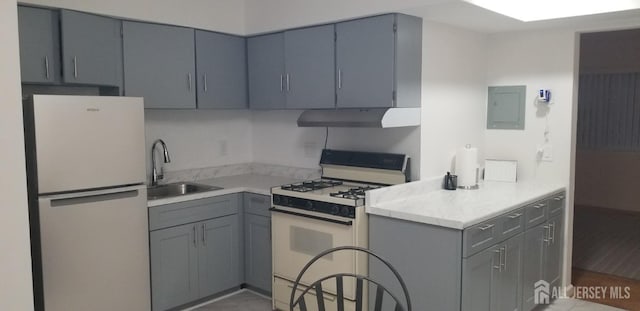 57 Judson St Unit 6A, Edison, NJ 08837 - kitchen with white appliances, a sink, under cabinet range hood, and gray cabinetry