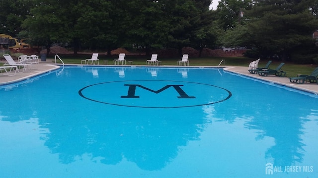 view of swimming pool with a yard and a patio area