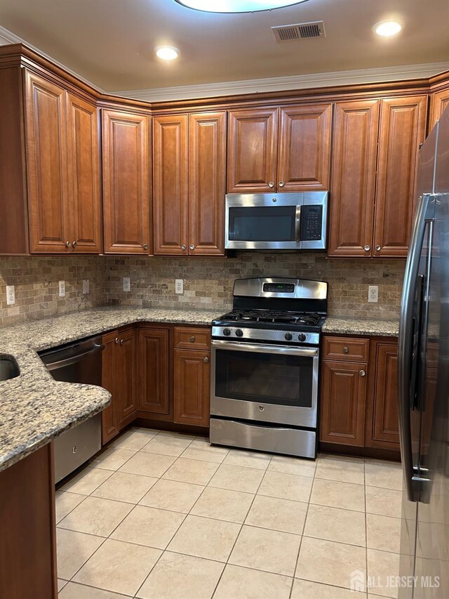 4207 Cedar Village Blvd, East Brunswick, NJ 08816 - kitchen featuring appliances with stainless steel finishes, light tile patterned floors, tasteful backsplash, and ornamental molding