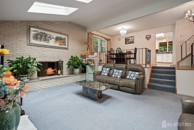 14 Bosko Dr, East Brunswick, NJ 08816 - living room with a chandelier, carpet floors, a brick fireplace, vaulted ceiling, and brick wall