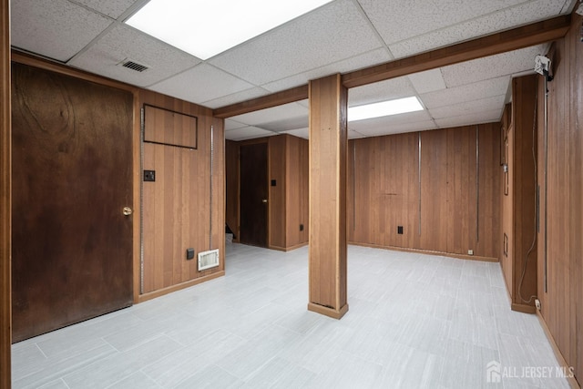 14 Bosko Dr, East Brunswick, NJ 08816 - finished below grade area featuring a drop ceiling, light flooring, and wood walls