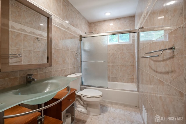 14 Bosko Dr, East Brunswick, NJ 08816 - full bath with tile walls, vanity, shower / bath combination with glass door, and tile patterned floors